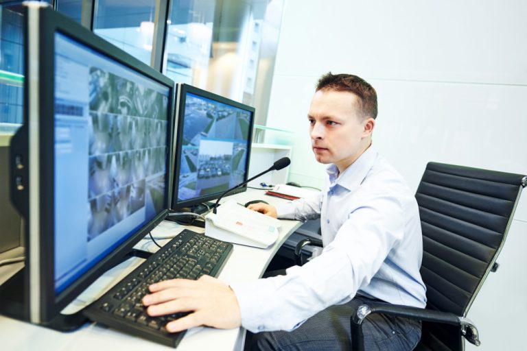 a man using a computer to check security systems